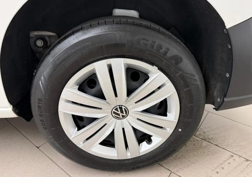 Gros plan sur la roue avant gauche blanche du Volkswagen Caddy 2.0 TDI 122 DSG7 Business 2025.