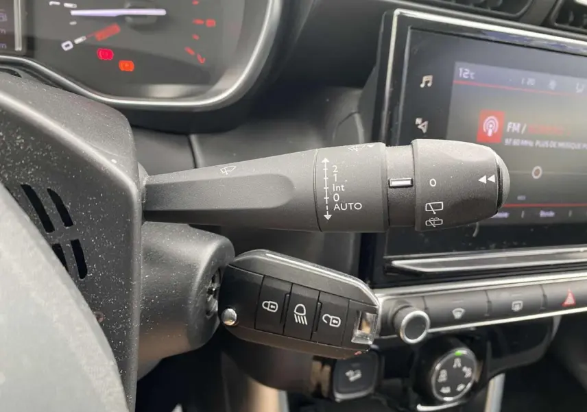 Gros plan sur la commande d'essuie-glace et la clé de contact dans l'habitacle gris du Citroën C3 Aircross 2020.