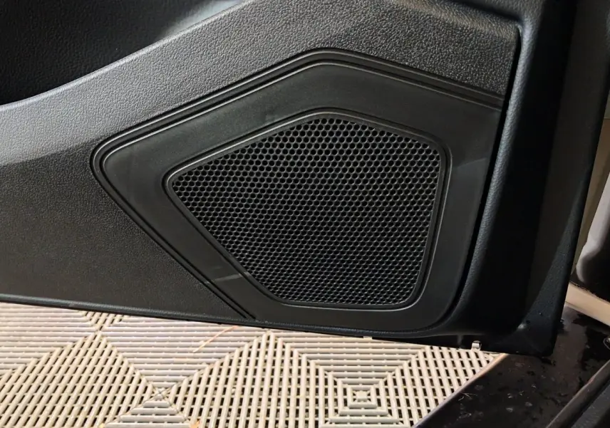 Gros plan sur le haut-parleur intégré à la porte côté conducteur de l'AIXAM AMBITION 0.5 CITY COUPE GTI blanc 2026.