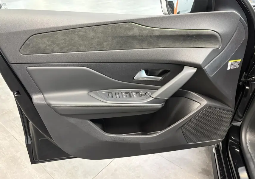 Panneau de porte avant gauche noir avec surpiqûres vert Adamite et commandes électriques sur Peugeot 308 GT 2026.