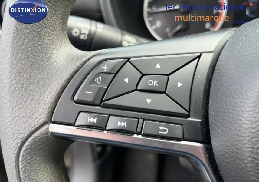 Gros plan sur les commandes multifonctions noires à gauche du volant du Nissan Juke 2023 noir métal.