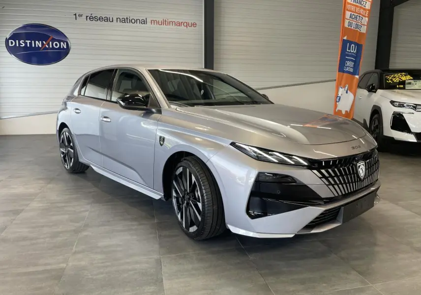 Peugeot 308 gris Artense vue 3/4 avant droit, calandre noire distinctive et jantes alliage bi-ton.