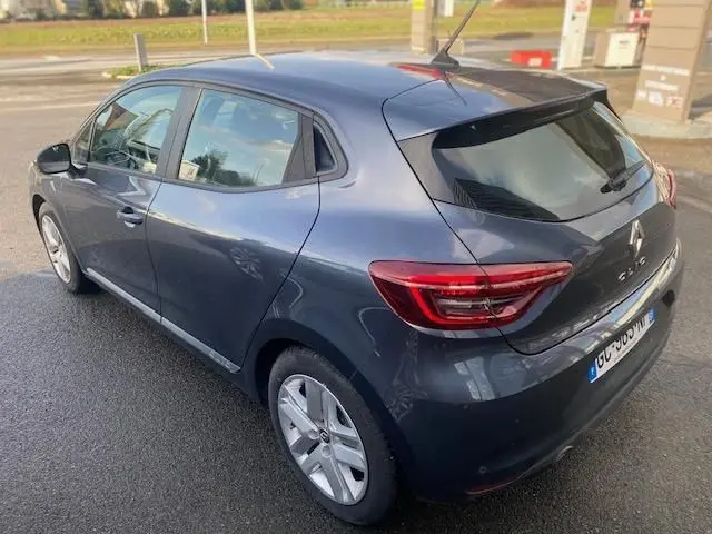 Vue 3/4 arrière droite d'une Renault Clio gris foncé 2021 à cinq portes avec feux arrière LED et vitres teintées.