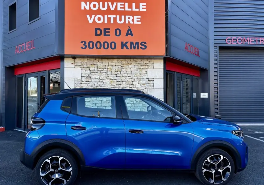 Profil côté gauche de la Citroën C3 100 BVM PLUS bleu 2025 avec toit noir et jantes au design moderne.