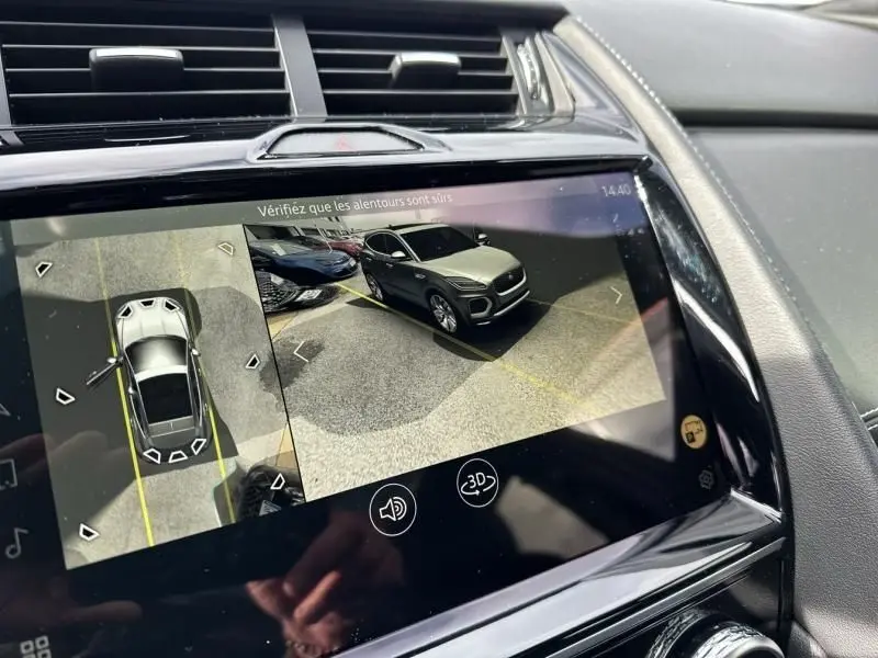 Vue écran intérieur montrant la caméra 360° d'une Jaguar E-PACE noire, angle 3/4 avant droit en parking.