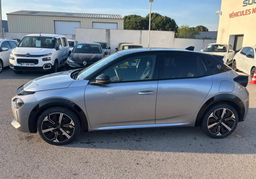 Profil droit de la Lancia Ypsilon 1.2 Ibrida gris 2025 avec jantes 17 pouces et toit noir contrasté.