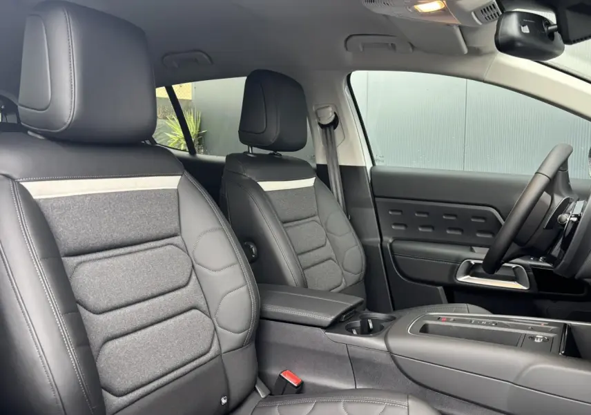 Vue intérieure côté conducteur et passager avant du Citroën C5 Aircross 2025 avec sièges Advanced Comfort en cuir et tissu gris.