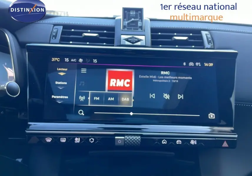 Écran tactile central du tableau de bord du DS7 noir métal 2024, affichant la radio RMC en mode FM.