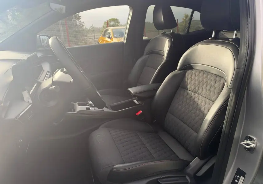 Vue intérieure côté conducteur du MG3 1.5 Hybrid+ 195ch Luxury 2025 en Cosmic Silver, sièges noir simili cuir/tissu avec surpiqûres rouges.