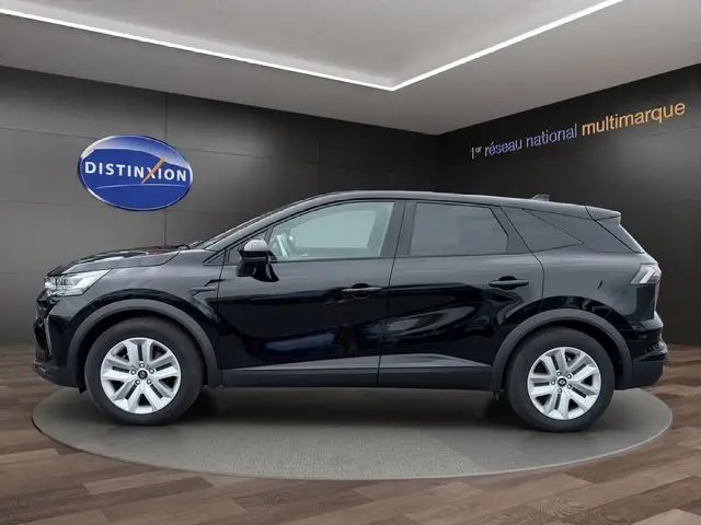 Vue latérale droite d'une Renault SYMBIOZ E-TECH Full Hybrid 145 Evolution noire, en présentation showroom avec jantes argentées.