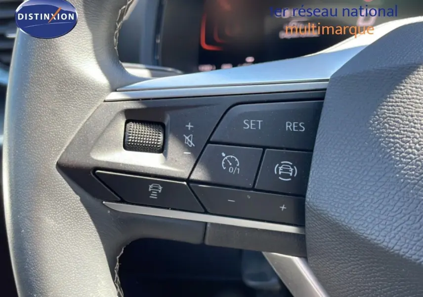 Gros plan sur les commandes de régulateur de vitesse au volant cuir noir d’un SEAT Arona 2025.