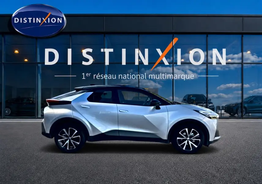 Profil côté gauche du Toyota C-HR gris 1.8 hybride 140 design 2025, avec jantes alliage et lignes anguleuses marquées.