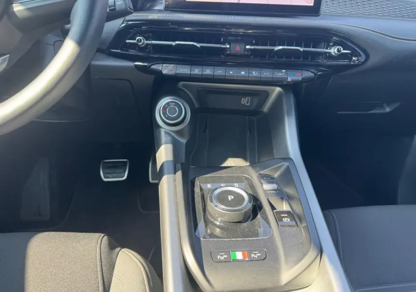 Vue rapprochée de la console centrale de l'Alfa Romeo Tonale 2025, avec sélecteur de boîte rotatif et finitions noires.
