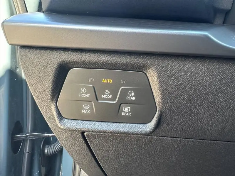 Panneau de commandes d’éclairage intérieur en plastique noir sur la gauche du tableau de bord d’un CUPRA Formentor bleu.