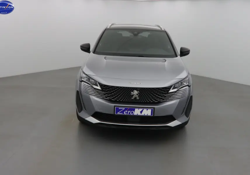 Vue frontale d'un Peugeot 3008 gris Artense métal avec calandre noire et logo lion central bien visible.