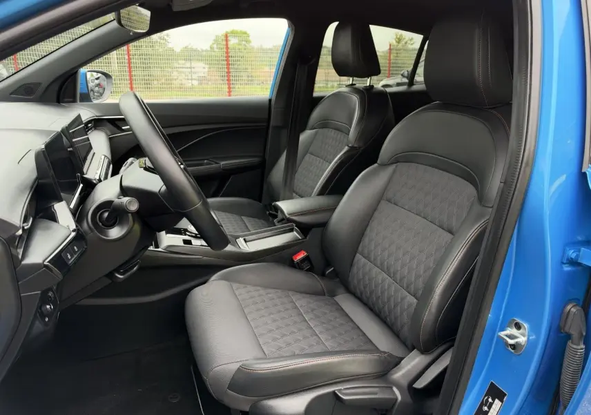 Vue intérieure côté conducteur du MG3 1.5 Hybrid+ 195ch Luxury 2025, sièges noir simili-cuir/tissu, portière Como Blue métallisé ouverte.