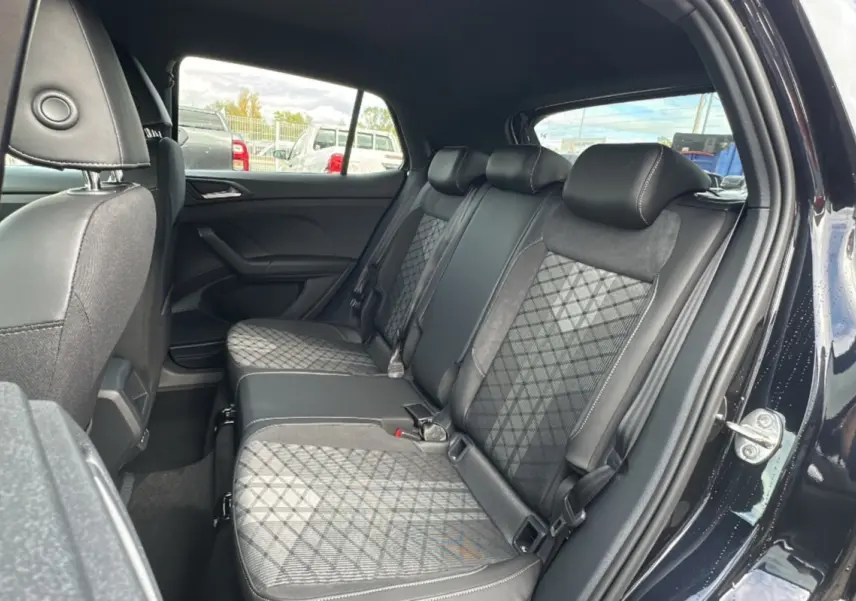 Vue intérieure côté droit sur la banquette arrière en tissu noir à motifs géométriques du Volkswagen T-Cross noir intense.