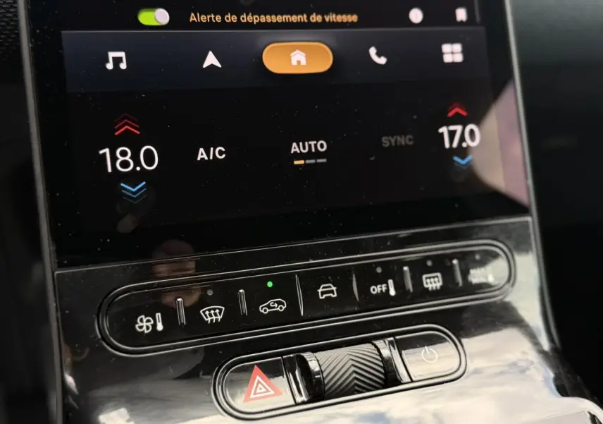 Gros plan sur la console centrale tactile du Citroën C5 Aircross hybride 2026 avec commandes climatisation et alertes visibles.