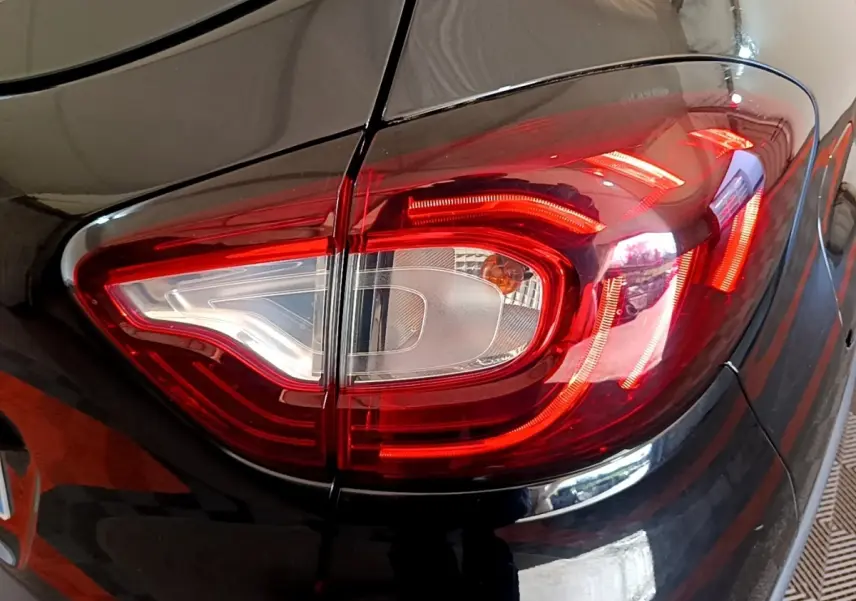 Gros plan sur le feu arrière droit rouge et blanc d’un Renault Captur Business TCe 90 noir de 2018.
