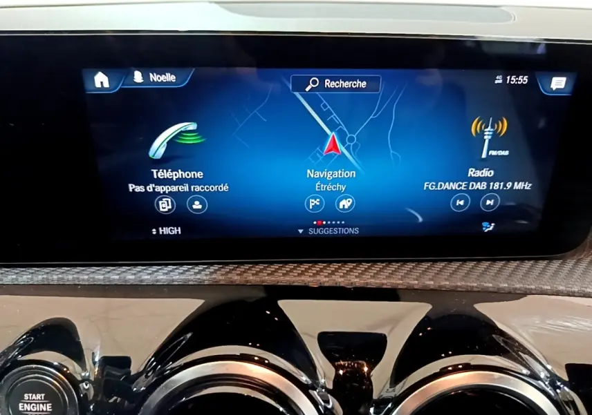 Écran tactile central affichant navigation, téléphone et radio dans une Mercedes Classe A blanche, vue intérieure avant.