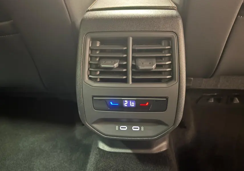 Vue rapprochée de la console arrière du CUPRA Formentor 2024 avec réglage de climatisation à 21°C et ports USB.
