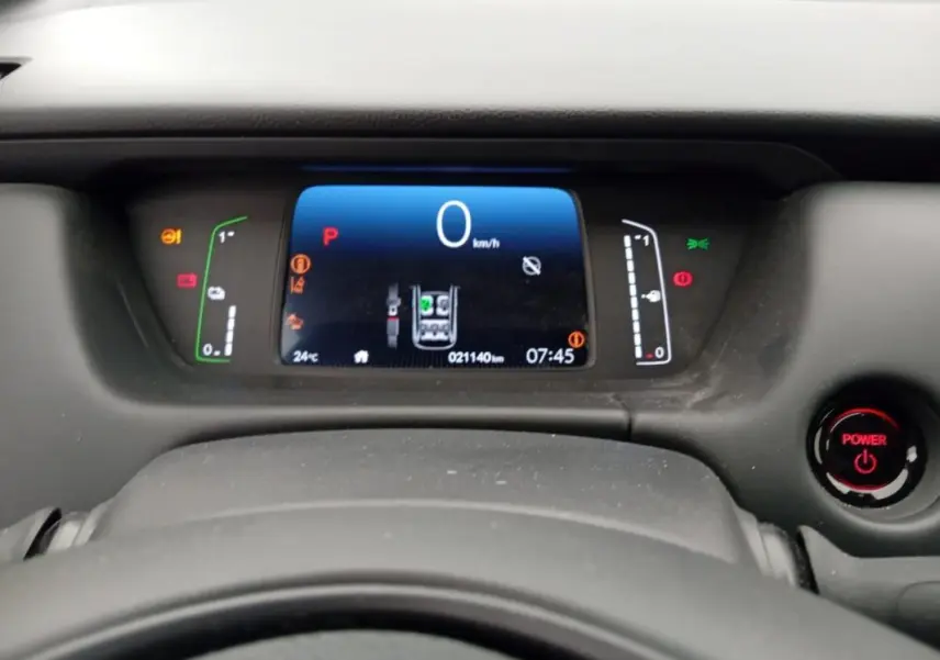 Tableau de bord numérique de la Honda Jazz 2024 noir, affichant la vitesse à 0 km/h et le bouton Power rouge visible à droite.