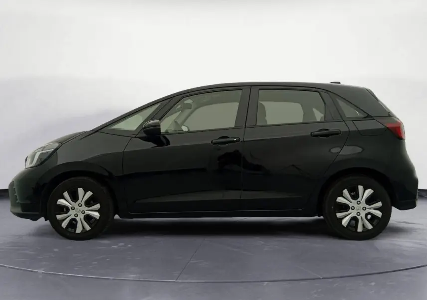 Profil droit de la Honda Jazz 2024 noire E:HEV 1.5 i-MMD Advance, compacte avec jantes alliage distinctives.