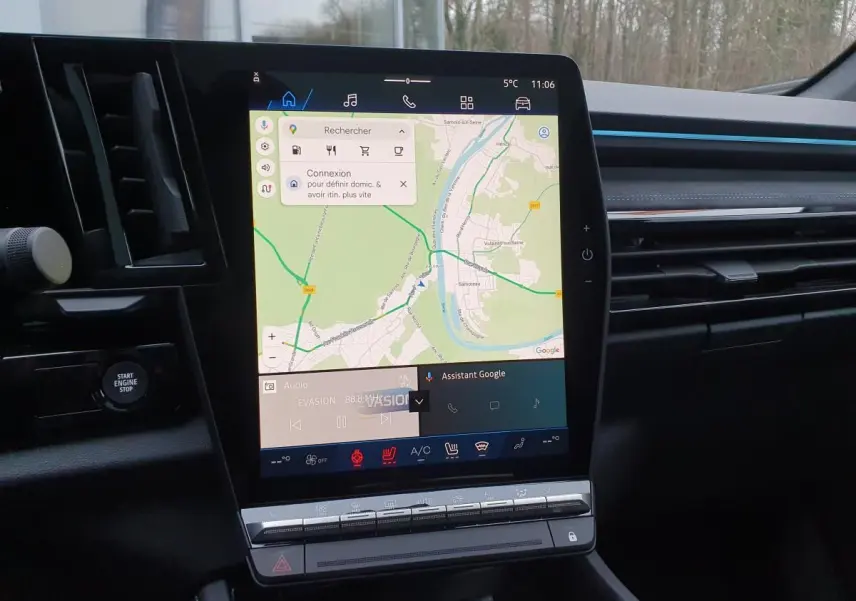 Vue intérieure centrée sur l’écran tactile vertical du tableau de bord du Renault Austral gris schiste avec toit noir.