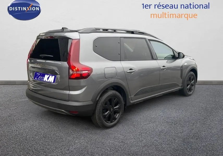 Vue 3/4 arrière droite d'un Dacia Jogger gris schiste métallisé avec vitres arrière teintées et jantes noires.