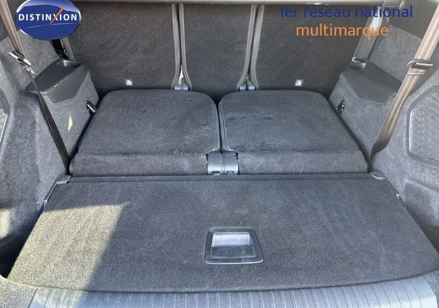 Coffre spacieux du Peugeot 5008 blanc Okenite, sièges arrière rabattus, vue depuis l'ouverture arrière.