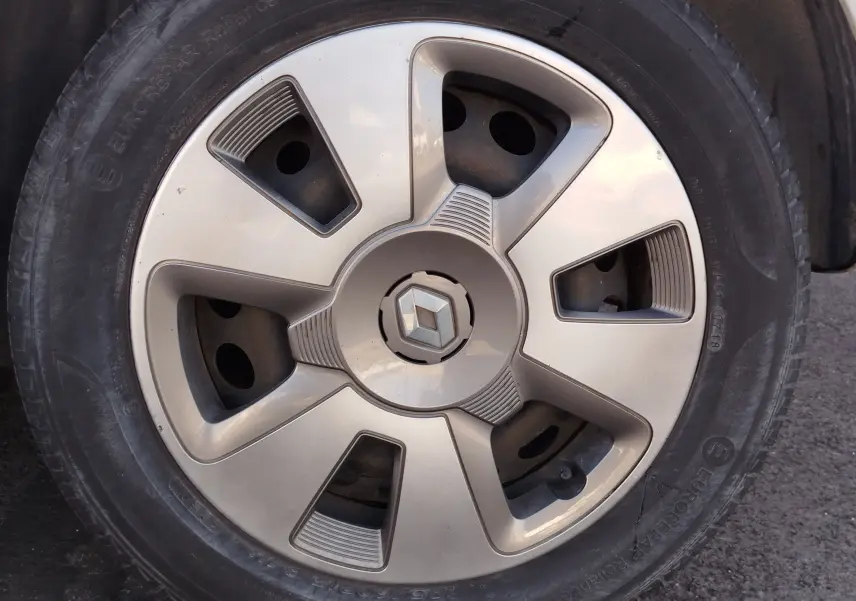 Gros plan sur la jante argentée d'une Renault Twingo Blanc Cristal, avec logo Renault au centre.