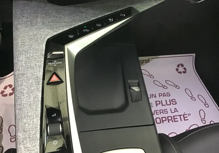 Vue plongeante sur la console centrale du Peugeot 3008 gris titane, mettant en valeur les commandes tactiles et le bouton Drive Mode.