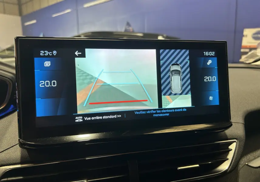 Écran tactile du tableau de bord du Peugeot 3008 gris Platinium montrant la caméra de recul et la température intérieure à 20°C.