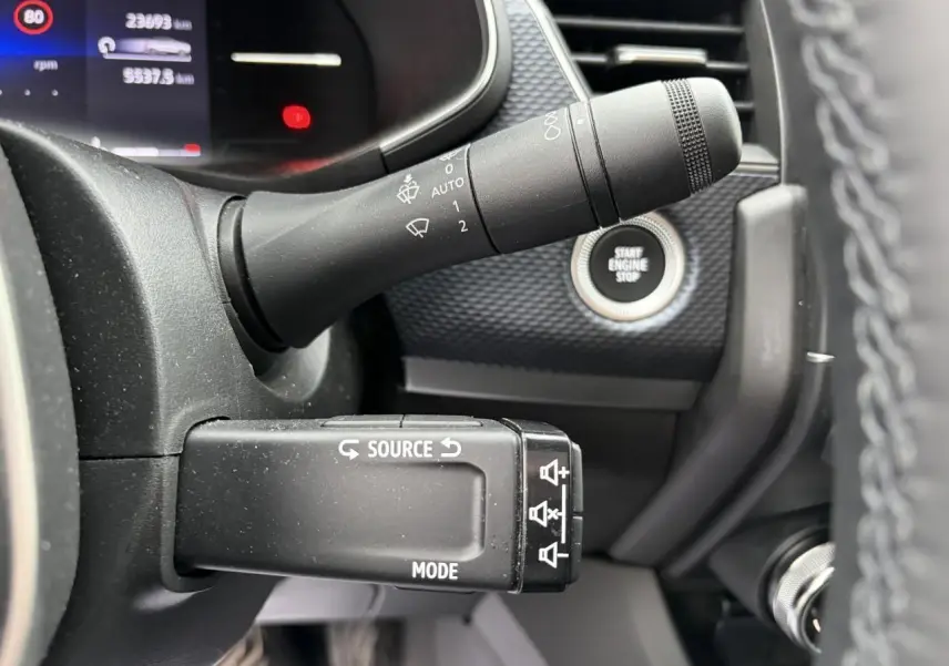 Gros plan sur la commande multimédia et la manette d’essuie-glace du tableau de bord du Renault Arkana 2025.