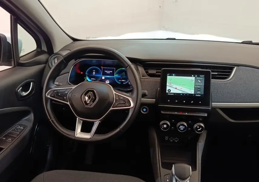 Vue intérieure avant de la Renault ZOE blanche 2021, volant cuir multifonctions et écran tactile central allumé.