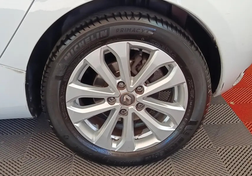 Gros plan sur la roue avant gauche blanche d’une Renault ZOE Zen R135 avec jante alliage et pneu Michelin.