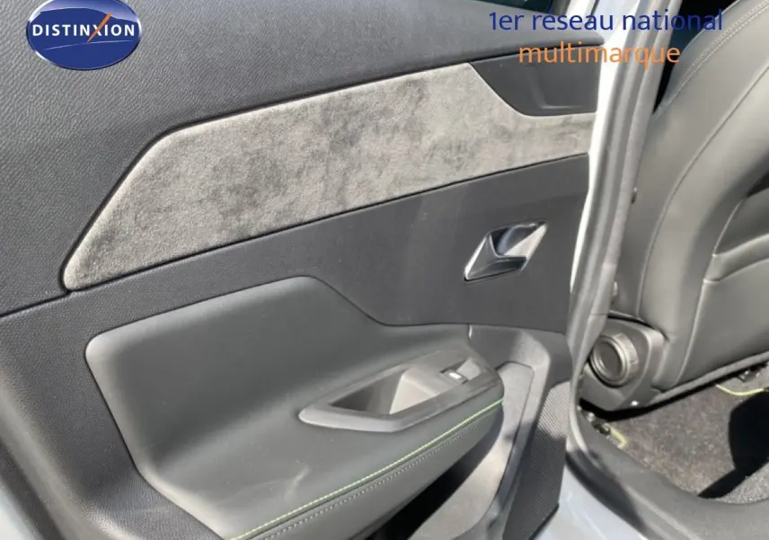 Vue intérieure côté gauche de la porte arrière d'une Peugeot 308 Hybrid blanche avec garniture tissu et cuir noir.