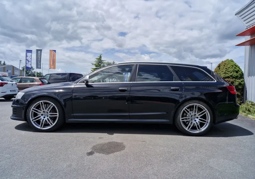Vue de profil côté gauche d'une Audi RS6 Avant noire de 2009 avec jantes alliage sport et vitres teintées.