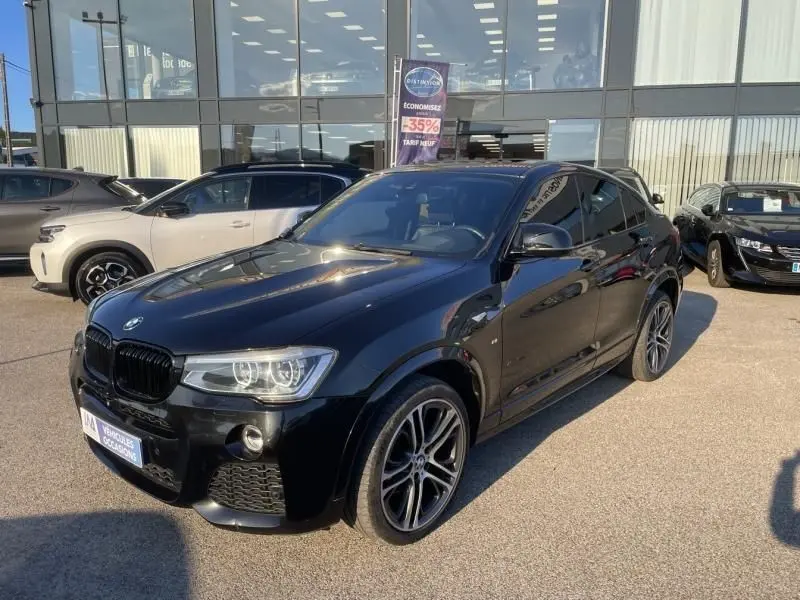 BMW X4 30DA X DRIVE M Sport noir métal en 3/4 avant droit, avec jantes sport et calandre noire brillante.
