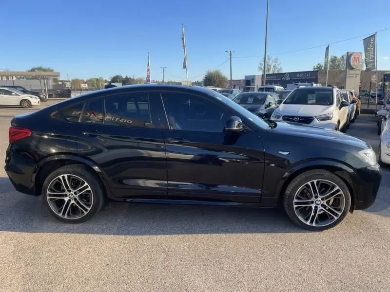 BMW X4 30DA X Drive 2016 noir métal vue de profil côté gauche, avec jantes alliage M Sport visibles.