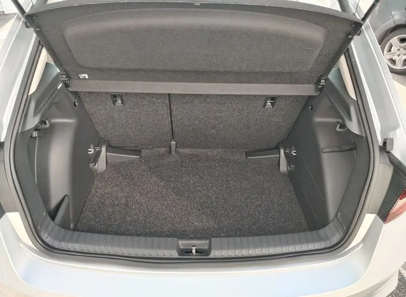 Coffre ouvert vu de dessus d'une Skoda Fabia blanche 2023, montrant un espace de chargement propre et vide.