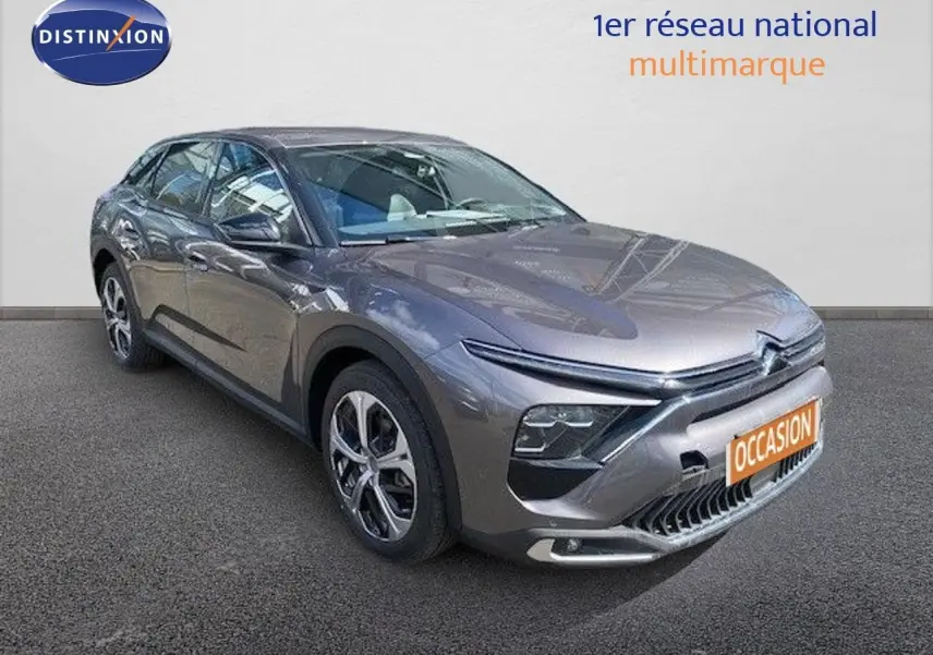 Vue 3/4 avant d'une Citroën C5 X gris platinium métal avec calandre distinctive et jantes bi-ton.