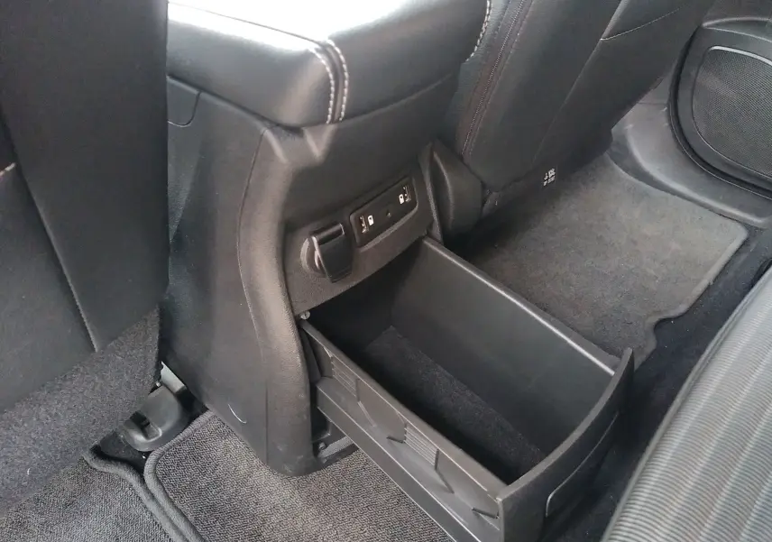 Rangement ouvert sous l'appui central arrière avec prises USB dans l'habitacle d'un Renault Grand Scenic IV.