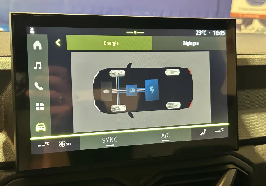 Écran tactile intérieur montrant le schéma énergétique hybride du Dacia Bigster 2026, vue frontale du tableau de bord.