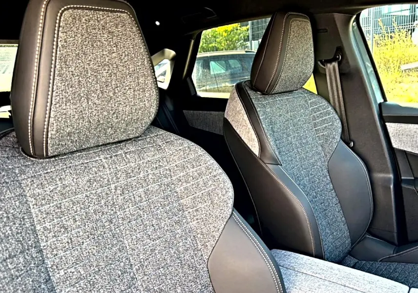 Gros plan sur les sièges avant en tissu gris et cuir noir du Peugeot 3008 1.2 hybrid 145 allure e-dcs6.
