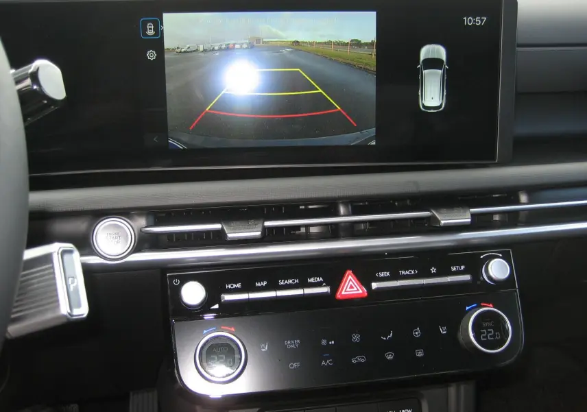Vue rapprochée de l'écran central et de la console du Hyundai Tucson 2025, affichant la caméra de recul et les commandes climatisation.