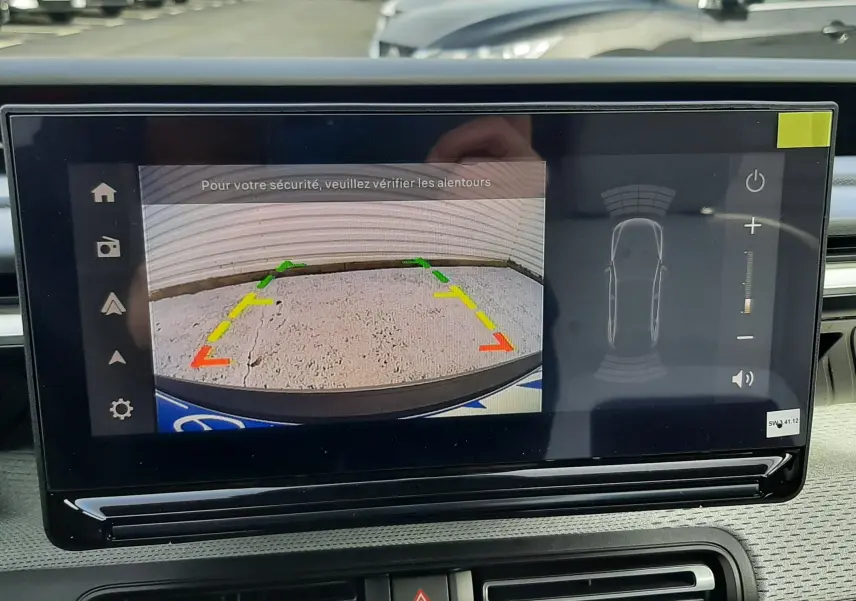 Écran central affichant la caméra de recul avec guidage coloré dans un Citroën C3 Aircross hybride 2026, intérieur noir.