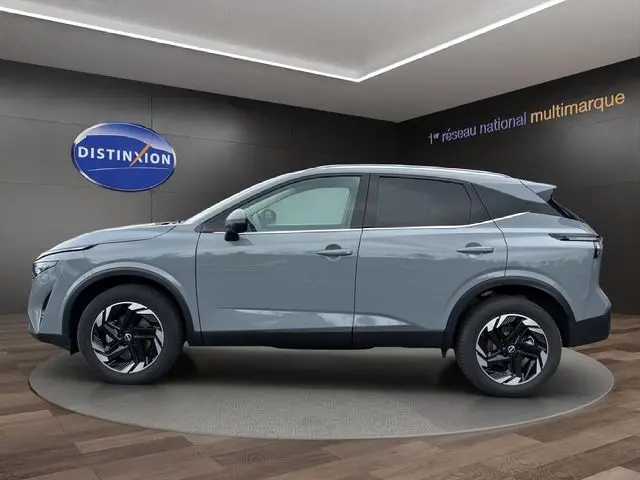 Vue de profil côté gauche d'un Nissan Qashqai 2025 gris céramique avec jantes noires et toit noir contrasté.