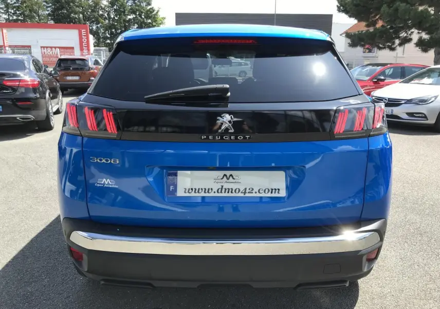 Vue arrière d'un Peugeot 3008 bleu Iron avec feux arrière à griffes rouges et bandeau noir brillant.