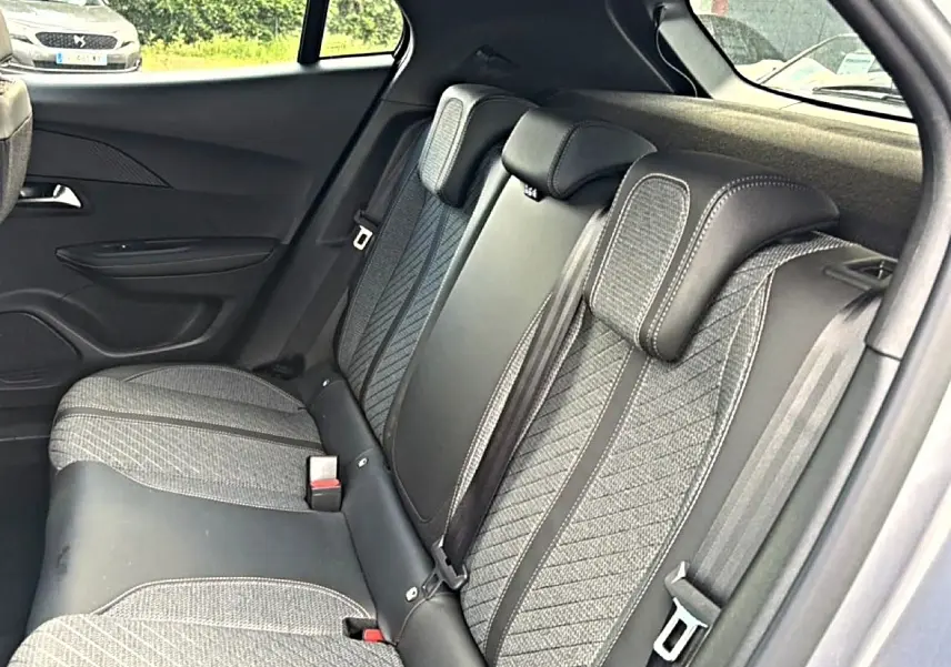 Vue intérieure des sièges arrière du Peugeot 2008 gris artense, mettant en valeur le tissu casual lomsa embossé et les appuie-têtes réglables.